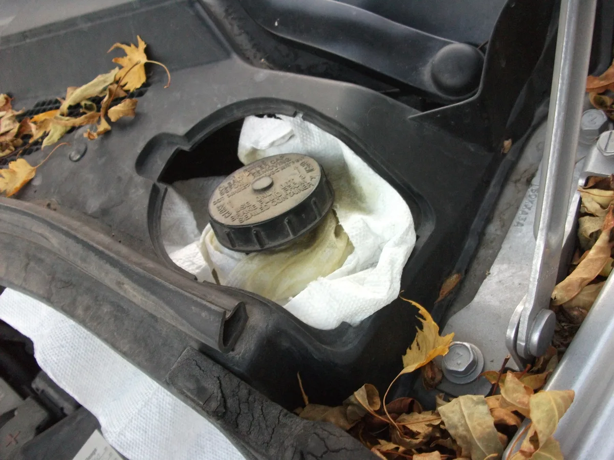 A car brake-fluid reservoir photographed during maintenance.