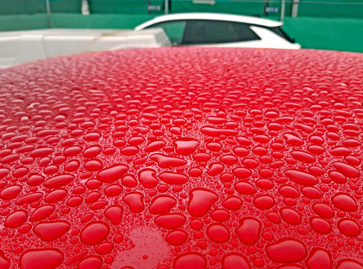 Raindrops on polished car paint, shown as a paint-care category example.