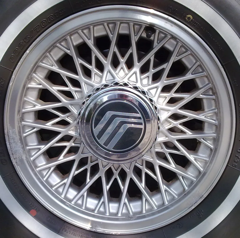 A close photograph of an automobile alloy wheel and tire.